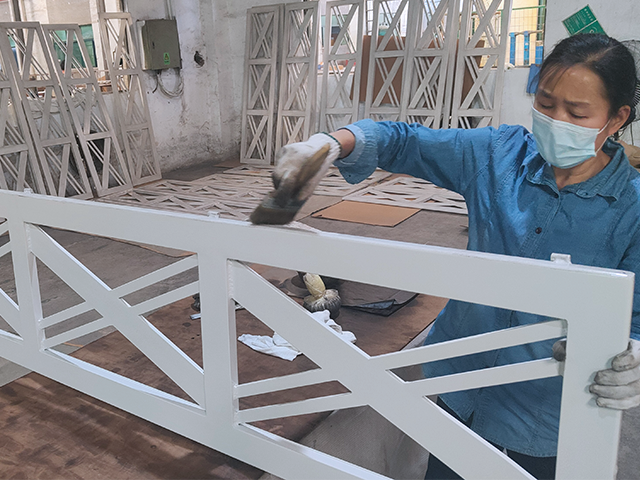 Worker assembling aluminum outdoor furniture frames