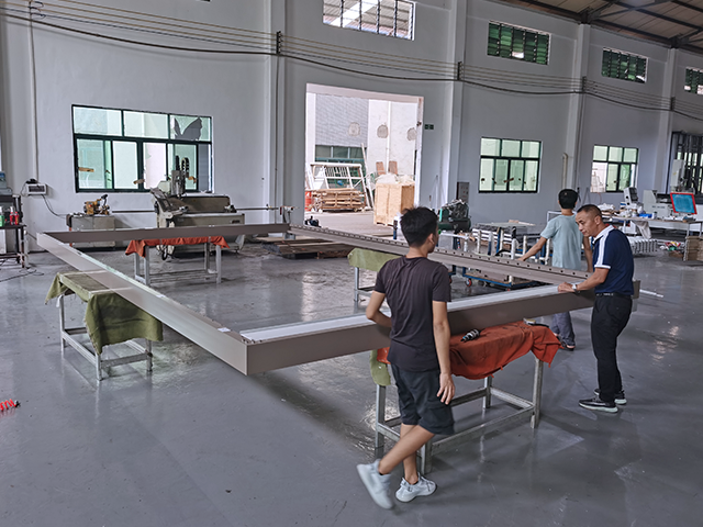 Worker producing aluminum outdoor kitchen components